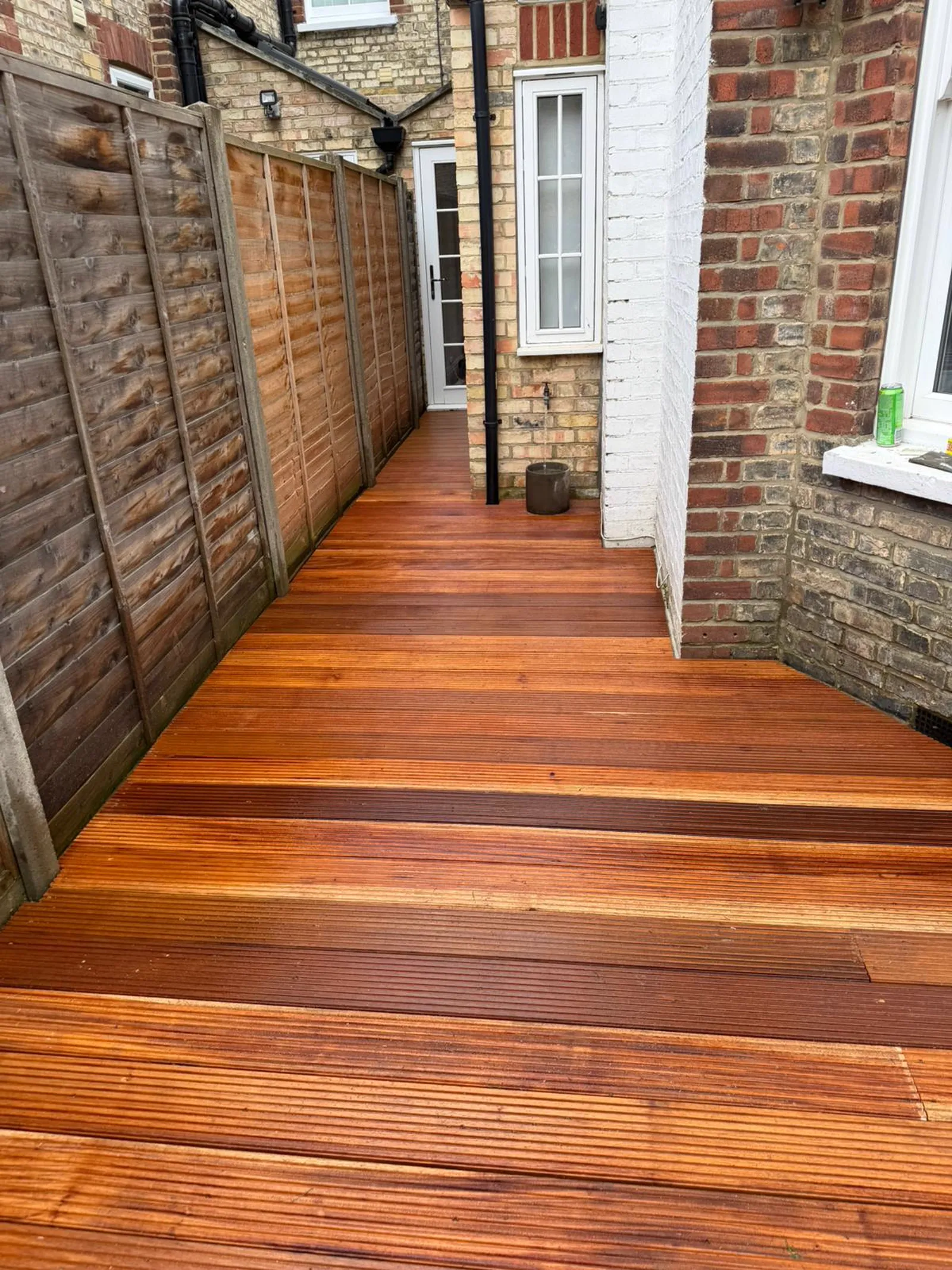 Newly installed Balau hardwood decking along a garden path, completed by The Tree Amigos Landscaping in South East London