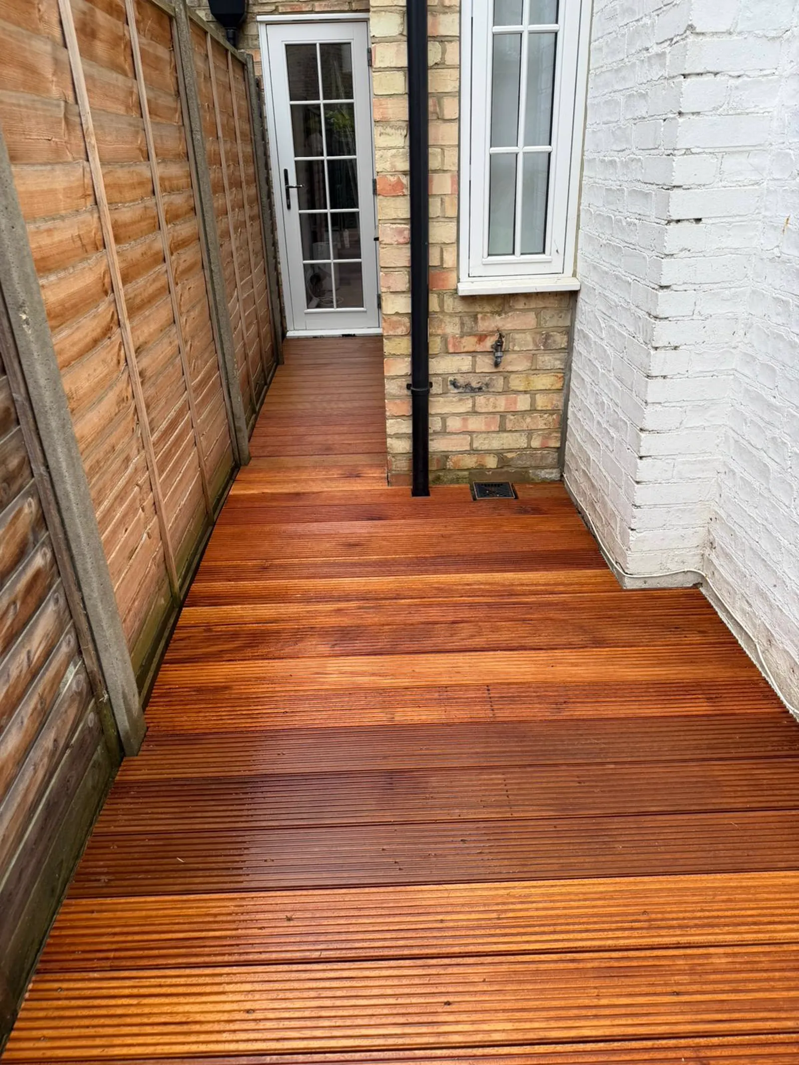 Balau hardwood timber decking installation leading to a rear garden door, completed by The Tree Amigos Landscaping in South East London