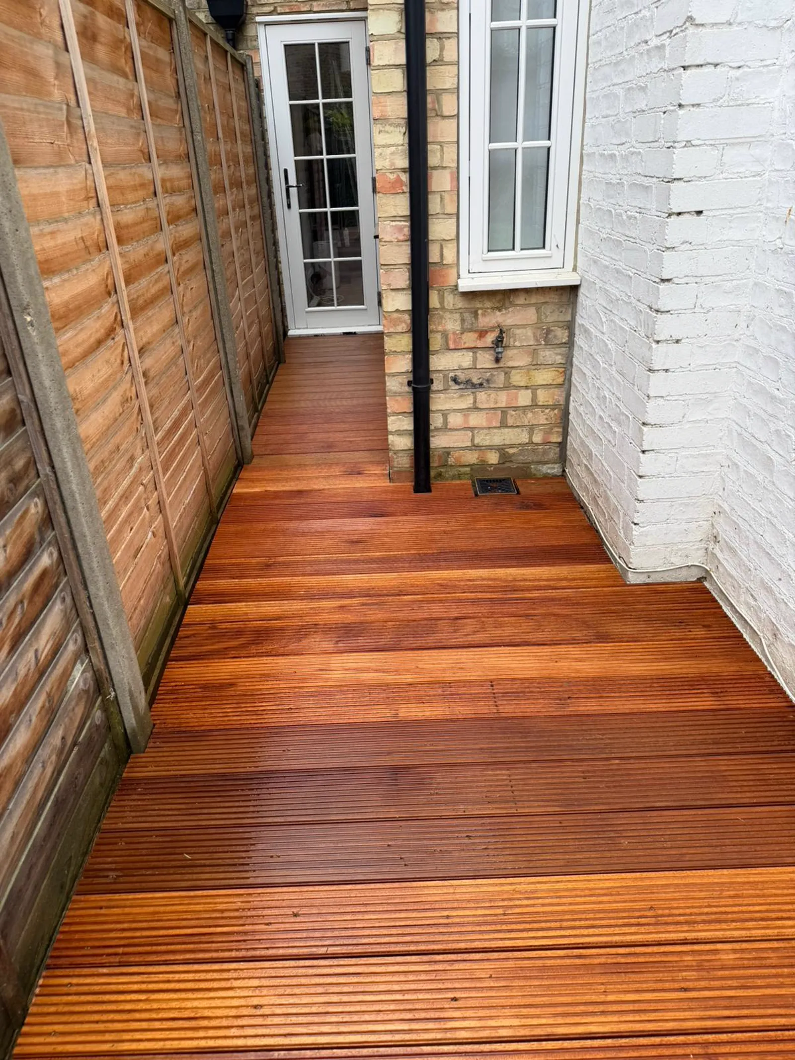 Finished Balau hardwood decking project showcasing the natural grain and rich tones of the timber, South East London