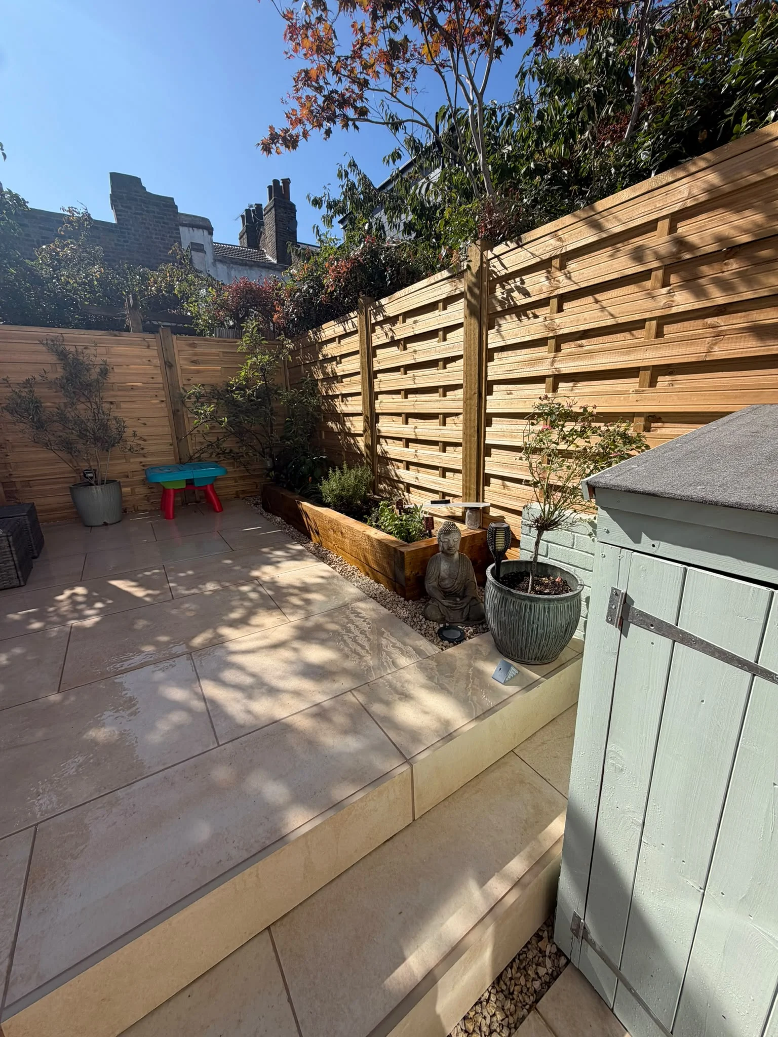 Newly installed timber fencing alongside a porcelain patio in a Greenwich, London garden by The Tree Amigos